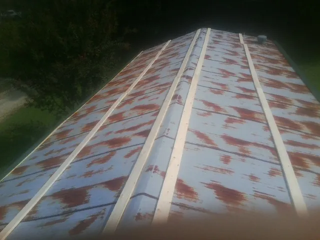 Rusted metal roof panels with new wood purlins before replacement — Storm Damage Roof Repair in Gurnee by Roofing Brothers