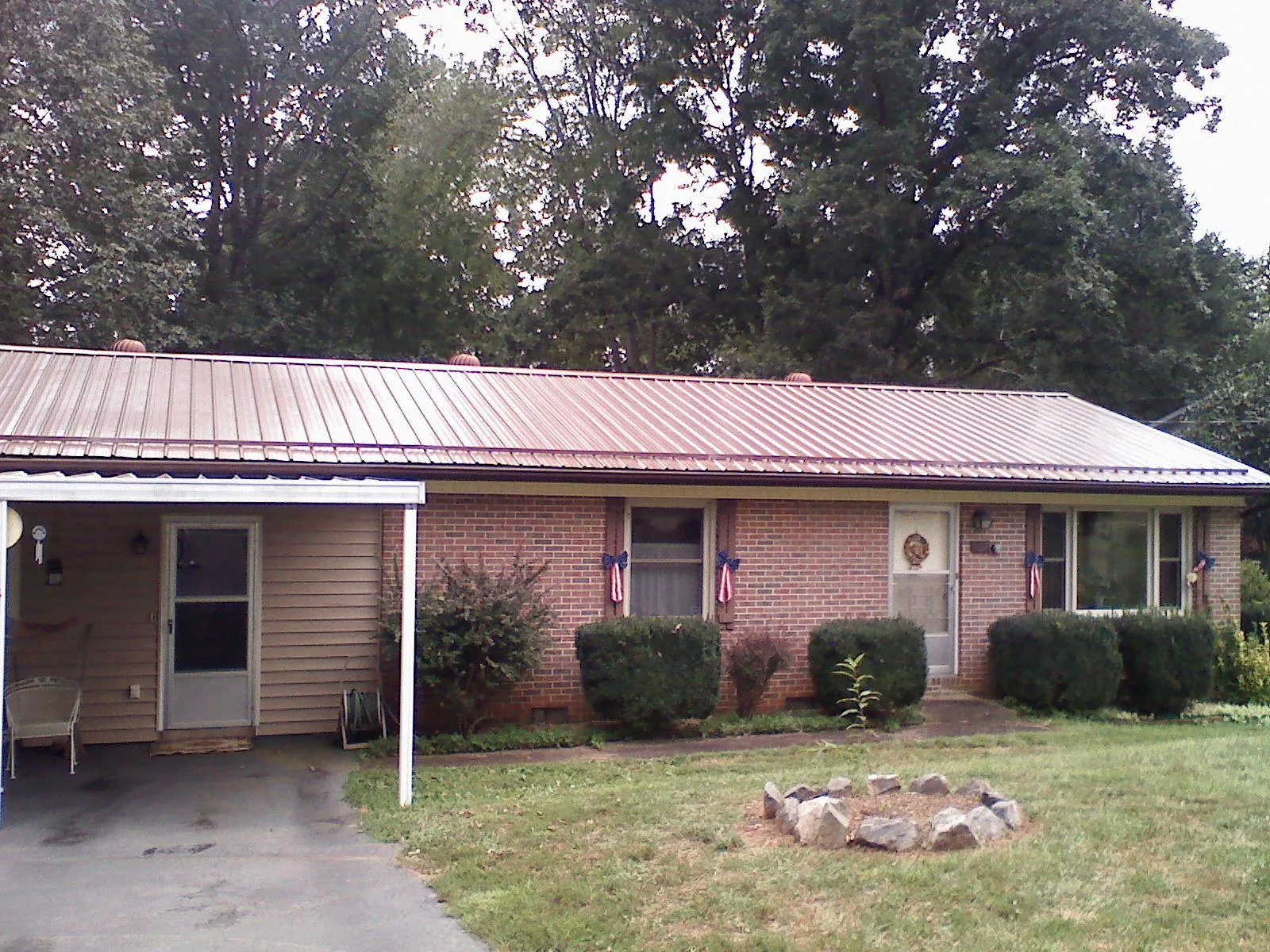 Bronze metal roof and carport on a brick ranch home — Roof Repair work by our crew in Gurnee