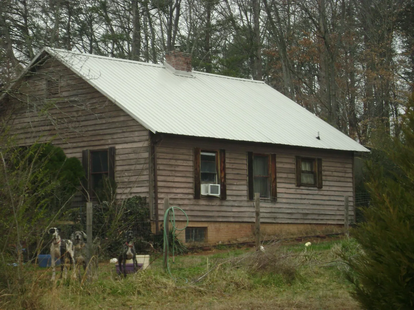 White metal roof on an old wood sided farmhouse, from a Asphalt Shingle Roof Repair job in Gurnee